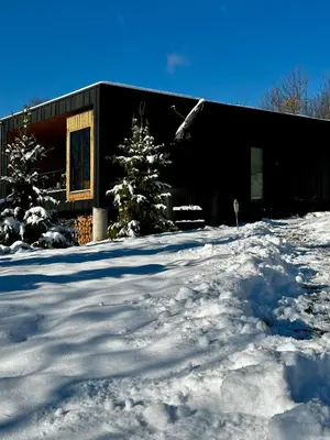 a group of logs on the outside of a house at Brown Deer - z Sauną na Tarasie, Jacuzzi i Widokiem na Góry - by Deer Hills Luxury Apartments in Kocoń