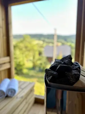 a box of clothes sitting on a window sill at Brown Deer - z Sauną na Tarasie, Jacuzzi i Widokiem na Góry - by Deer Hills Luxury Apartments in Kocoń