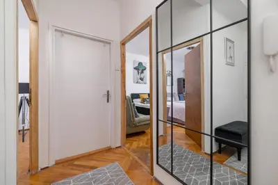 a mirror in a hallway with a living room at Rodzinny Apartament z dwiema sypialniami niedaleko centrum Krakowa by Noclegi Renters in Kraków