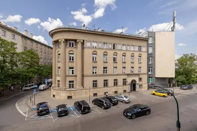 a large building with cars parked in front of it at Rodzinny Apartament z dwiema sypialniami niedaleko centrum Krakowa by Noclegi Renters in Kraków