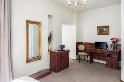 a room with a mirror and a desk with a mirror at Old Time Aparthotel in Kraków