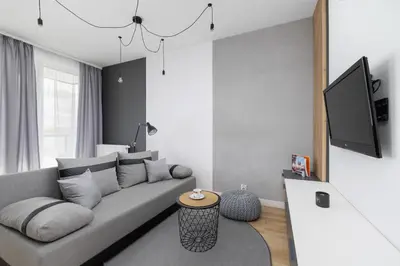 a living room with a couch and a tv at Elegant Apartment in Cracow with Balcony, Parking and Desk by Noclegi Renters in Kraków
