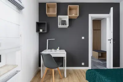 a room with a desk with a chair and a bed at Elegant Apartment in Cracow with Balcony, Parking and Desk by Noclegi Renters in Kraków