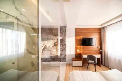 a bedroom with a desk and a television in a room at Agawa restauracja&Hotel in Dębno