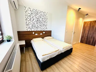 a bedroom with a bed in a room with a wall at Agawa restauracja&Hotel in Dębno