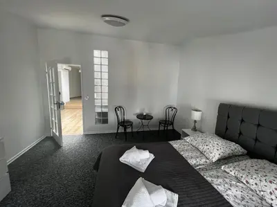 a bedroom with a bed and a table and chairs at Apartament - Old Town in Kraków