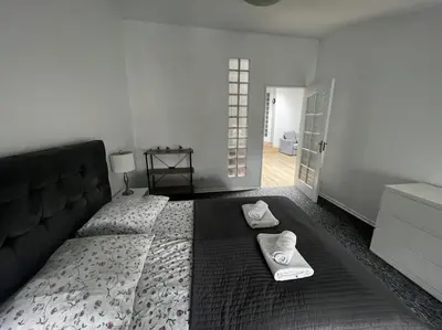 a bedroom with a large bed with towels on it at Apartament - Old Town in Kraków