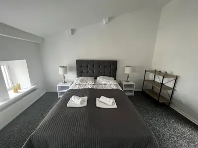a bedroom with a large bed with two towels on it at Apartament - Old Town in Kraków