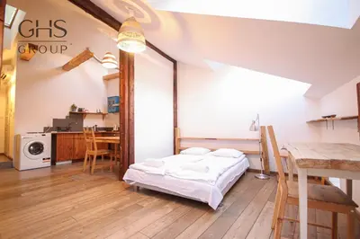 a room with a bed and a table and a microwave at Klasyczny apartament obok Wawelu Old Town in Kraków