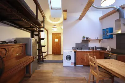 a kitchen with a stairs leading to a laundry room at Klasyczny apartament obok Wawelu Old Town in Kraków