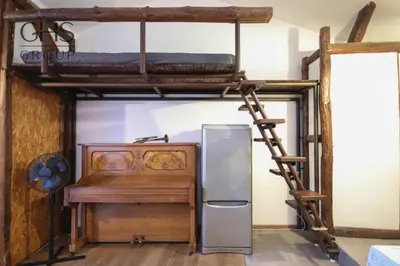 a room with a bunk bed and a refrigerator at Klasyczny apartament obok Wawelu Old Town in Kraków