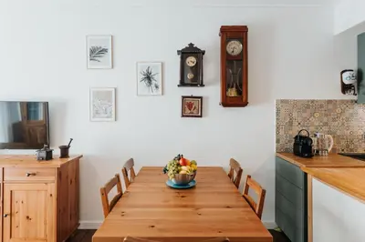a kitchen with a wooden table with a bowl of fruit on it at ICE next to the Wawel Castle Free Parking Two Cars in Kraków