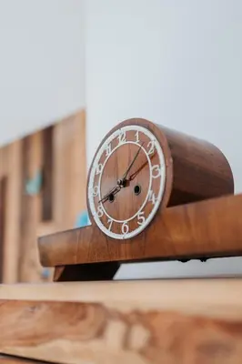 a clock sitting on top of a wooden table at ICE next to the Wawel Castle Free Parking Two Cars in Kraków