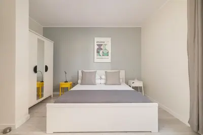 a white bedroom with a large white bed in it at 1 bedroom Apartment with Terrace - Wawrzyńca 21 in Kraków