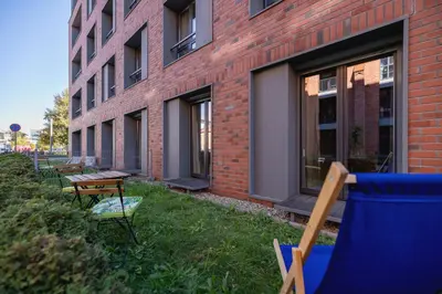 a row of chairs and tables in front of a building at 1 bedroom Apartment with Terrace - Wawrzyńca 21 in Kraków