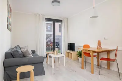 a living room with a couch and a table at 1 bedroom Apartment with Terrace - Wawrzyńca 21 in Kraków