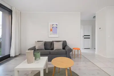 a living room with a couch and a table and chairs at Apartment with Terrace - Wawrzyńca 21 Street in Kraków