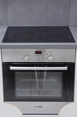 a stove with an oven with a clock on it at Apartment with Terrace - Wawrzyńca 21 Street in Kraków
