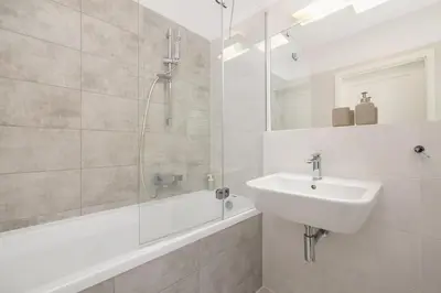 a white bathroom with a sink and a shower at Apartment with Terrace - Wawrzyńca 21 Street in Kraków