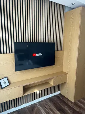 a flat screen tv sitting on top of a wall at Sweet Dreams Apartments Kazimierz in Kraków