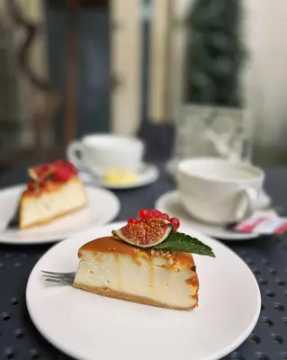 a piece of cake on a white plate on a table at Sweet Dreams Apartments Kazimierz in Kraków