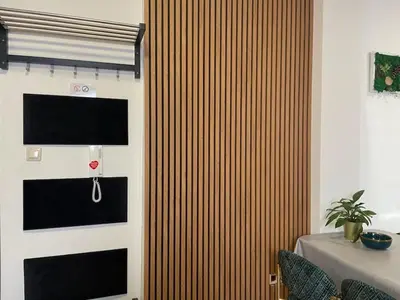 a room with a wooden wall with a television on it at Apartament Solny Wieliczka Centrum 3 in Wieliczka