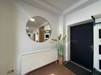 a hallway with a mirror and a door at Apartament Solny Wieliczka Centrum 3 in Wieliczka