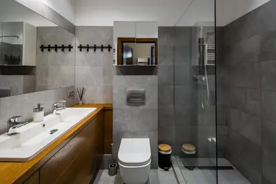 a bathroom with a toilet and a sink and a shower at Krowoderska Residence WAWELOFTS in Kraków