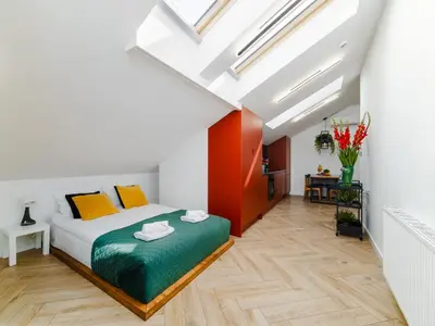 a bedroom with a bed and a skylight at Horizon Apartments - Luxury Studio, Old Town in Kraków
