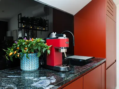 a red mixer sitting on a counter in a kitchen at Horizon Apartments - Luxury Studio, Old Town in Kraków