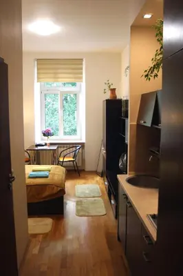 a living room with a kitchen and a dining room at Anna, City Center in Kraków