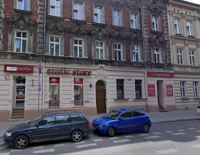 two cars parked in front of a building at Anna, City Center in Kraków