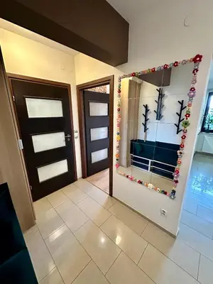 a room with a door with a mirror and a bedroom at Kaczary Deluxe 56m2 in Kraków