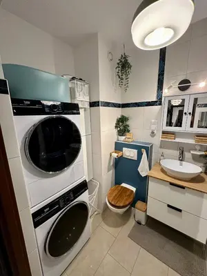 a kitchen with a microwave oven and a sink at Kaczary Deluxe 56m2 in Kraków