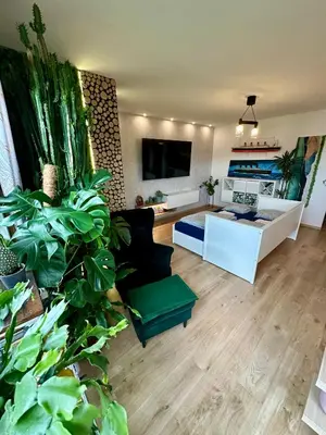a living room with a couch and a table at Kaczary Deluxe 56m2 in Kraków