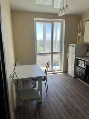 a kitchen with a table and chairs and a refrigerator at Vacation House of Tadeusz in Oświęcim