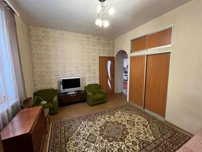 a living room with a television and green chairs at Vacation House of Tadeusz in Oświęcim