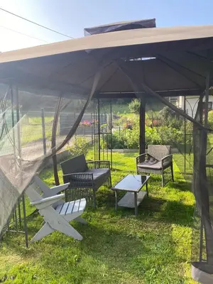 a group of chairs and a table under a tent at Apartament Koszarawa in Koszarawa