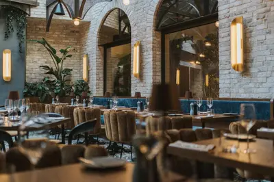 a restaurant with tables and chairs and a bar at Hotel Indigo Krakow - Wawel Castle by IHG in Kraków