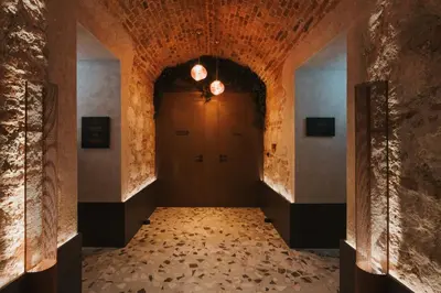 a living room with two chairs and a staircase at Hotel Indigo Krakow - Wawel Castle by IHG in Kraków