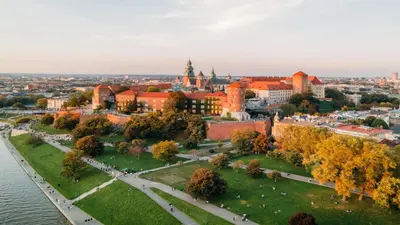 a restaurant with tables and chairs and windows at Hotel Indigo Krakow - Wawel Castle by IHG in Kraków