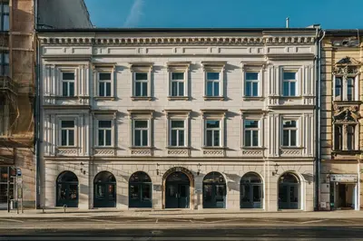 two entrances to a building with blue doors at Hotel Indigo Krakow - Wawel Castle by IHG in Kraków