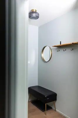 a black stool in a room with a mirror at Modern House in Old Town Numero 7 in Kraków