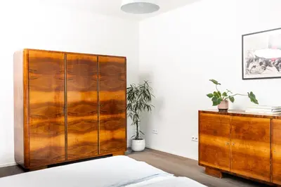 a wooden cabinet and a dresser in a room at Modern House in Old Town Numero 7 in Kraków