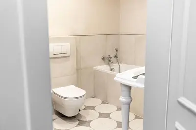 a bathroom with a toilet and a sink at Modern House in Old Town Numero 7 in Kraków