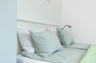 a white bed with white pillows on it at Modern House in Old Town Numero 7 in Kraków