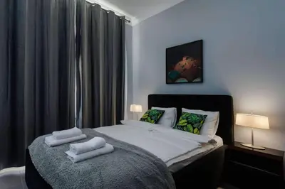 a bedroom with a bed with two towels on it at Malila Premium Apartaments Cracow City Center Rtm Zbigniewa Dunin Wąsowicza 3 in Kraków