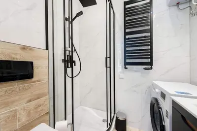 a shower with a glass door in a bathroom at Malila Premium Apartaments Cracow City Center Rtm Zbigniewa Dunin Wąsowicza 3 in Kraków