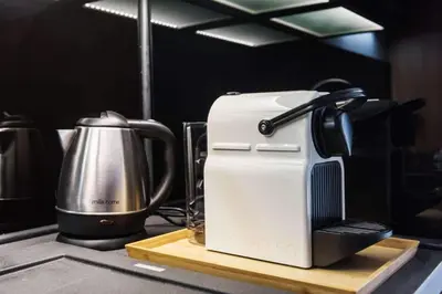a coffee maker sitting on a table next to a mixer at Malila Premium Apartaments Cracow City Center Rtm Zbigniewa Dunin Wąsowicza 3 in Kraków