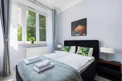 a bedroom with a bed with towels on it at Malila Premium Apartaments Cracow City Center Rtm Zbigniewa Dunin Wąsowicza 3 in Kraków
